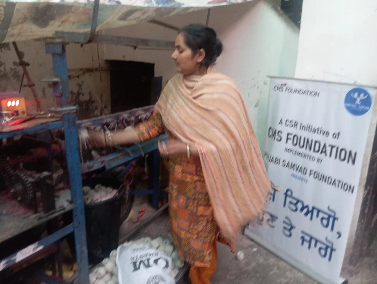 Anita working with production equipment after livelihood training