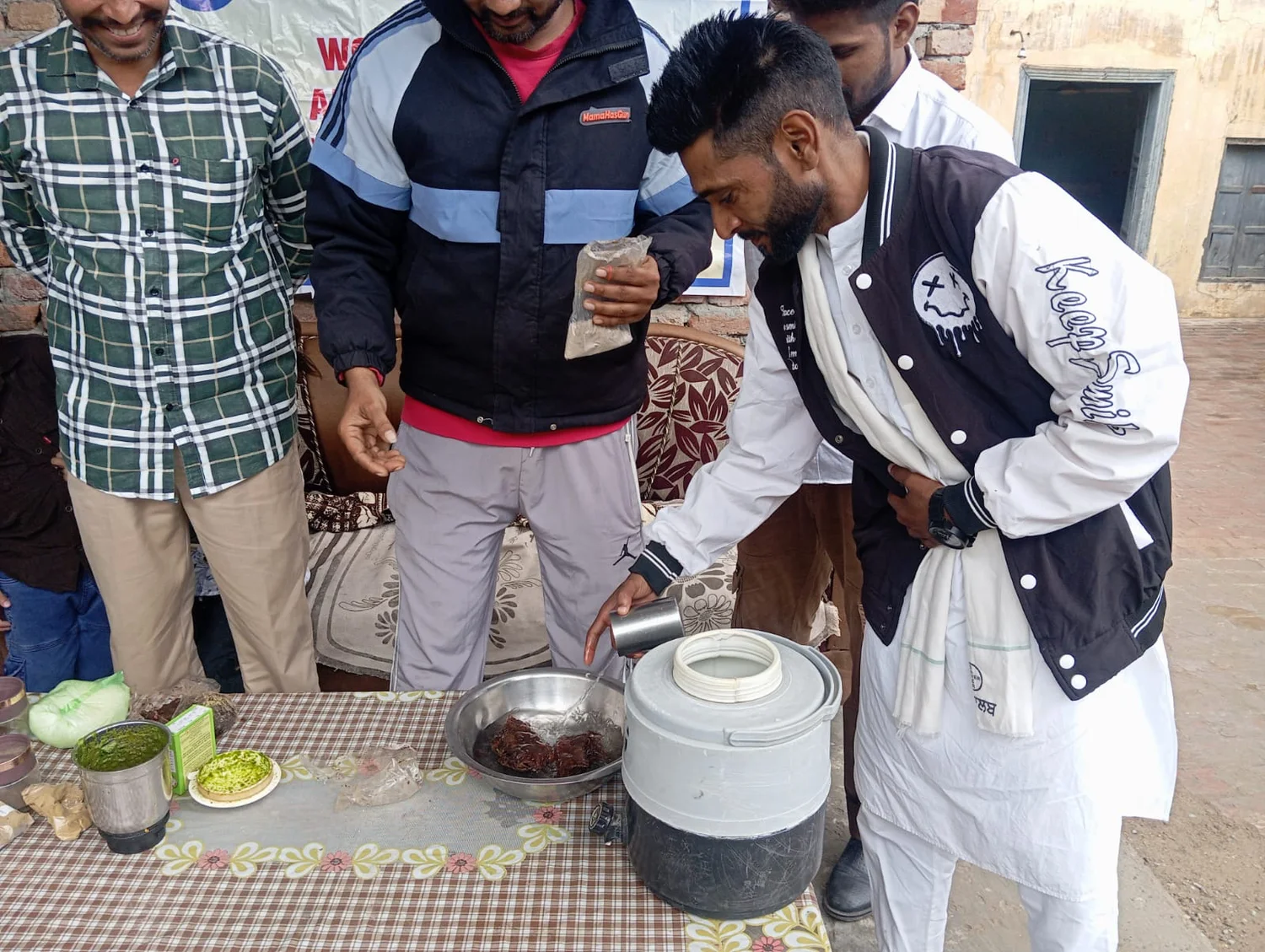 Harjinder Singh learning street-food preparation during a community training session