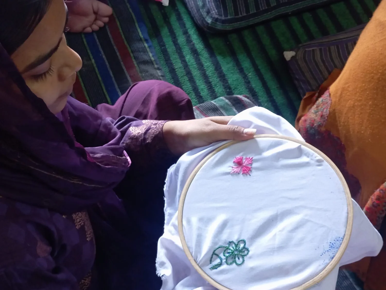 A young participant practising Phulkari embroidery